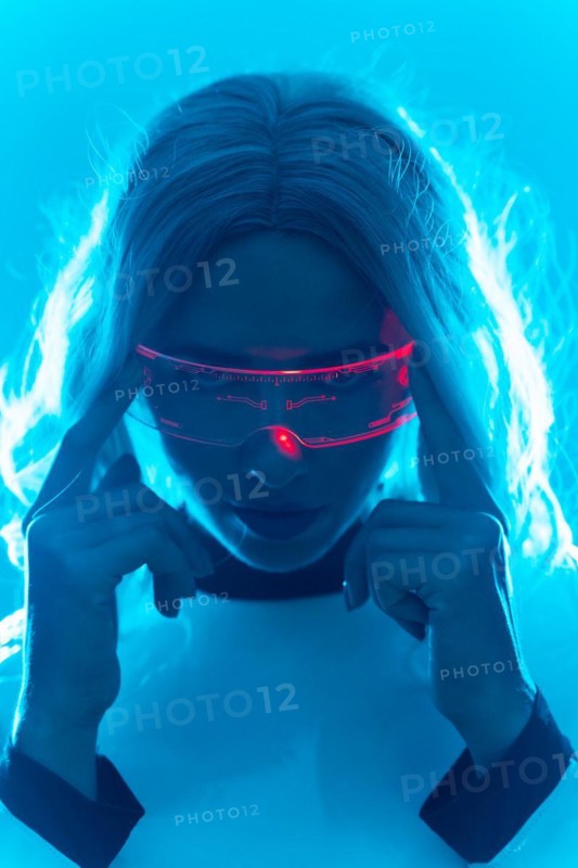 Portrait of a woman in a futuristic suit and glasses with blue led lights