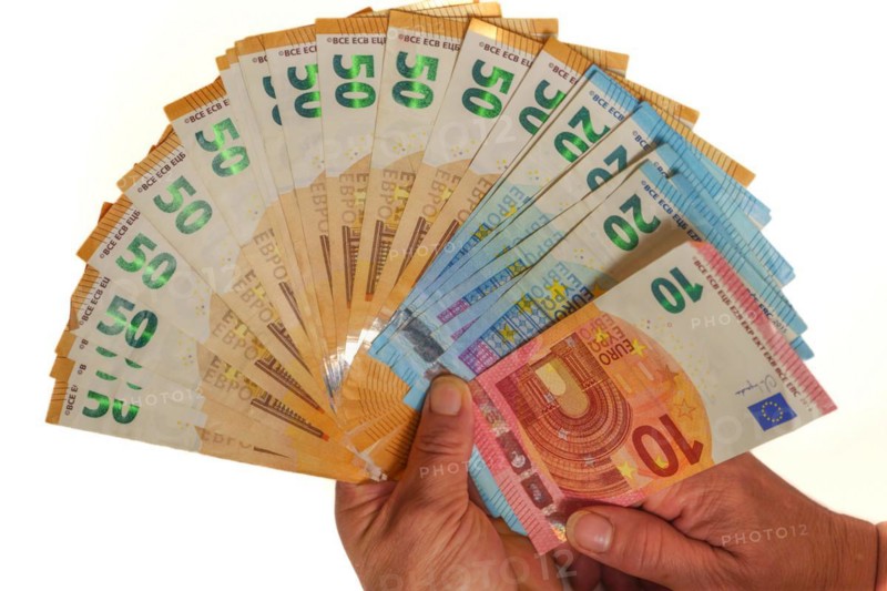 Woman's hands holding fan-shaped euro banknotes with white background and copy space