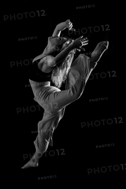 Young dancer in studio photo session with a black background