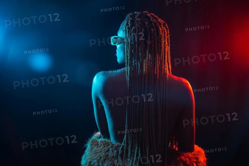 Woman of black ethnicity with braids with blue and red led lights