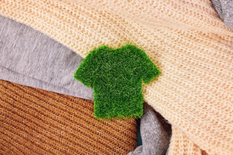 Concept for environmental friendly produced clothing with shirt made out of grass surrounded by sweaters