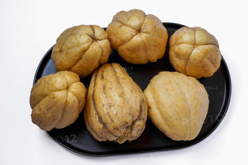Close-up of chayotes isolated on a white background on a black platter