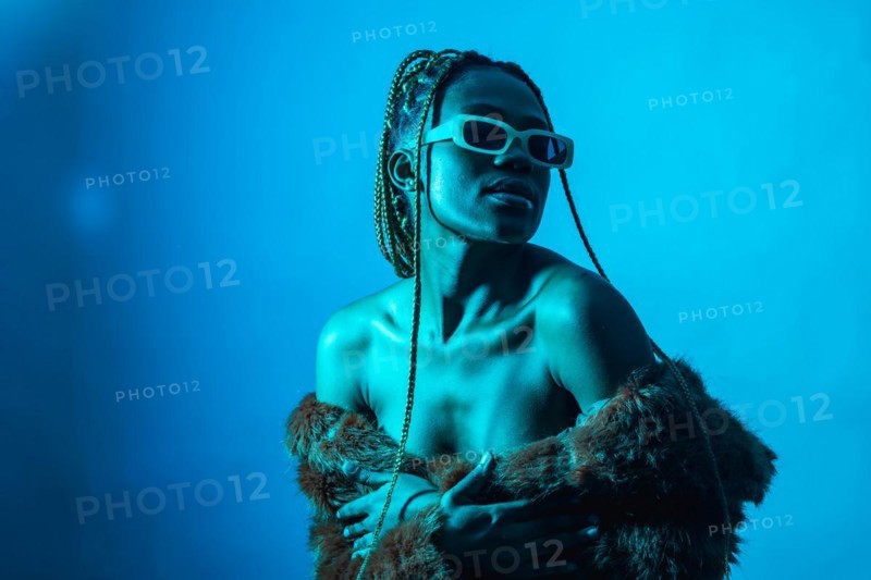 Attractive black ethnic woman with braids with blue led lights