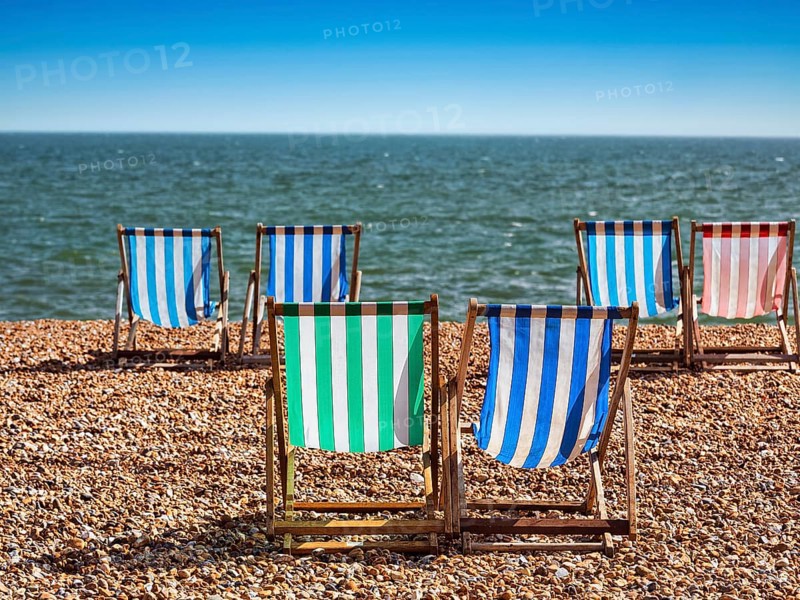 Colourful deckchairs by the sea