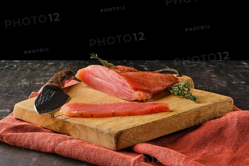 Air dried turkey breast on wooden cutting board