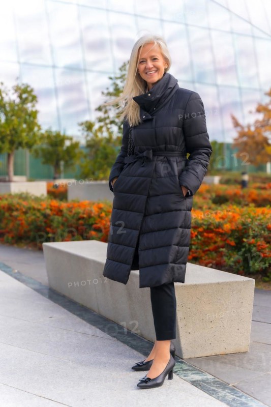 Corporate portrait of white-haired middle-aged businesswoman