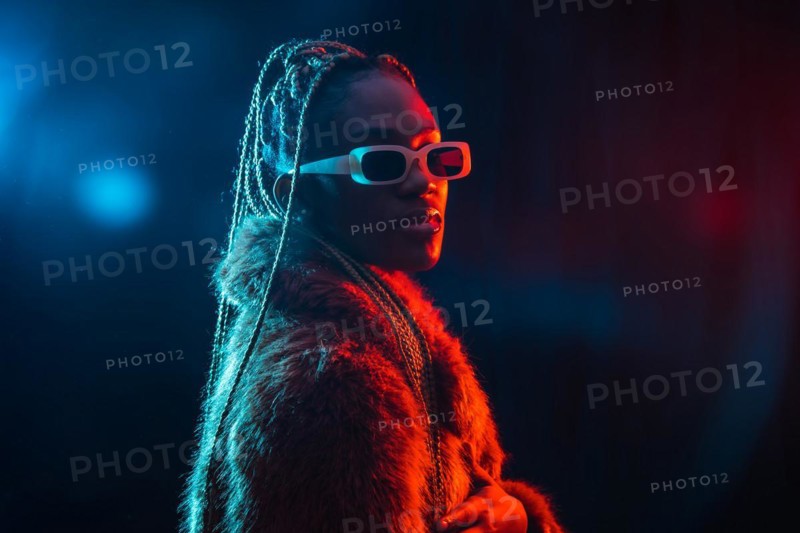 Black ethnic woman with braids with blue and red led lights