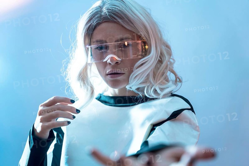 Woman with illuminated futuristic goggles