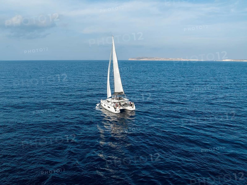 Sailing catamaran in full sail