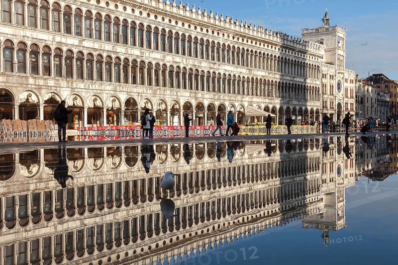 Reflection of the Procuratie Vecchie and the Torre dell Orologio in the high water of the Macus Square