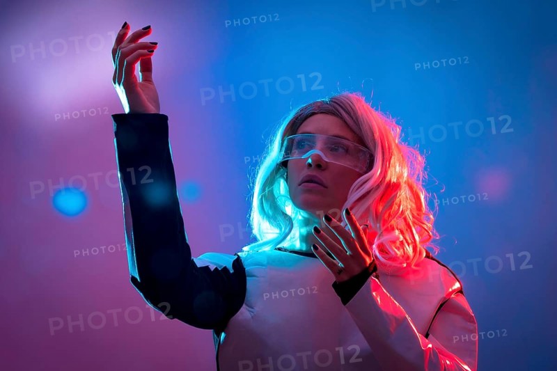 Beautiful woman looking through the futuristic glasses