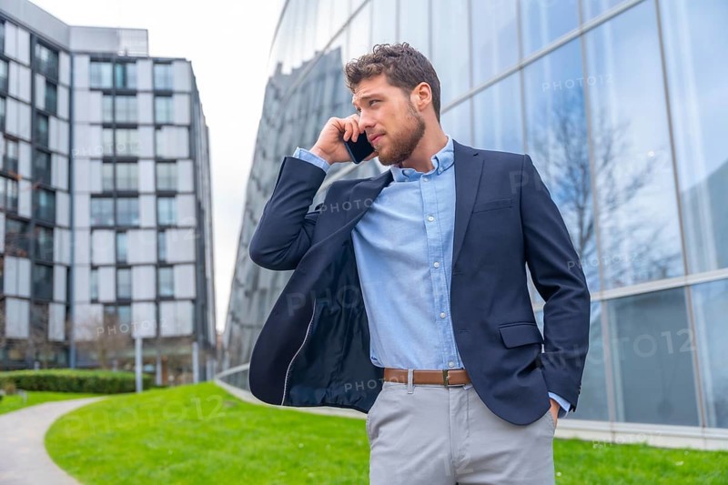 Businessman or finance man talking on the phone outside the office