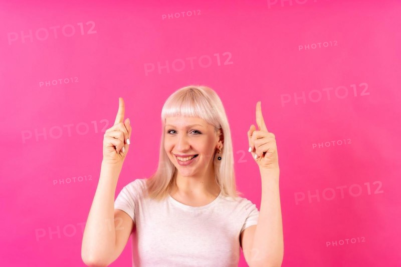 Blonde caucasian girl studio shot on pink background