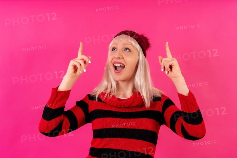 Blonde caucasian girl on pink background studio
