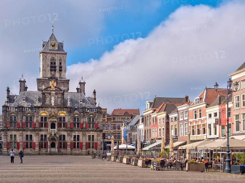 The beautiful Restored Town Hall Stadhuis Delft next to the traditional buildings on the Market Square