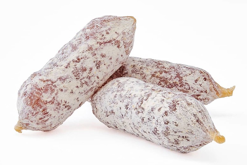 Closeup view of fermented mini parma sausages covered with white mold