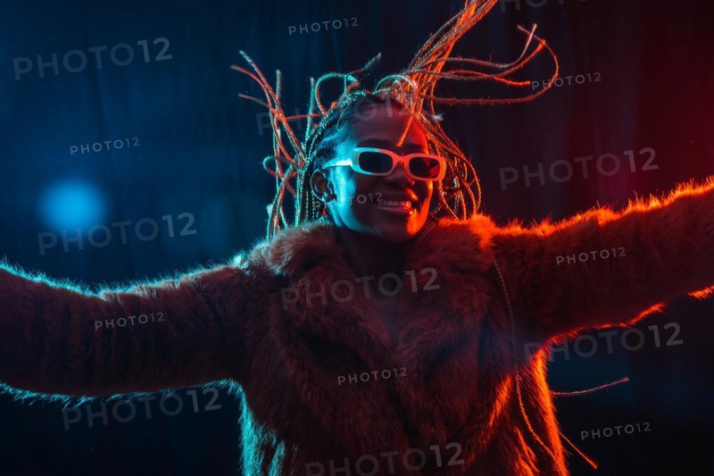 Black ethnic woman with braids with blue and red led lights