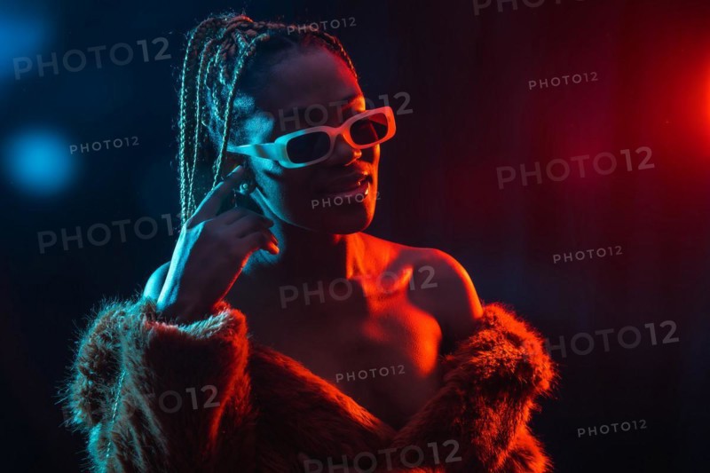 Black ethnic woman with braids with blue and red led lights