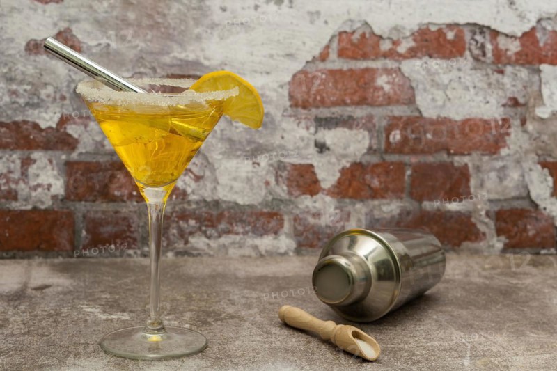 Refreshing squeezed lemon cocktail with ice and cocktail shaker