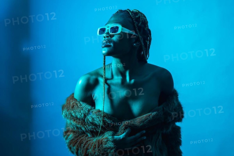 Attractive black ethnic woman with braids with blue led lights