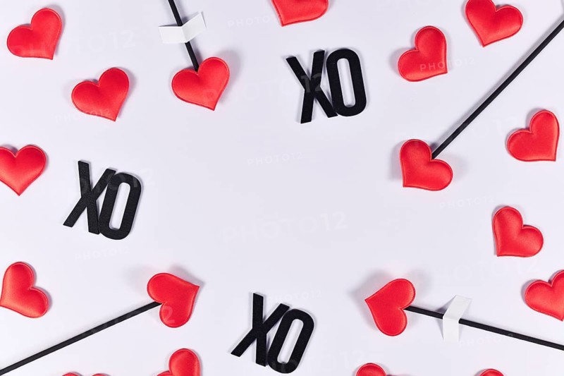 Valentne's day border with cupid's love arrows and text XO on white background with copy space
