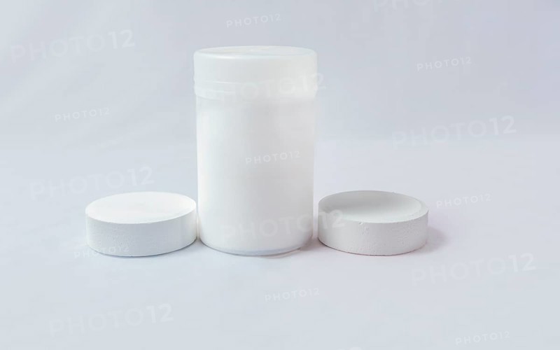 Swimming pool cleaning and maintenance chlorine tablets. Chlorine tablets for pool cleaning on isolated background. Chlorine tablets for swimming pool disinfection on white background