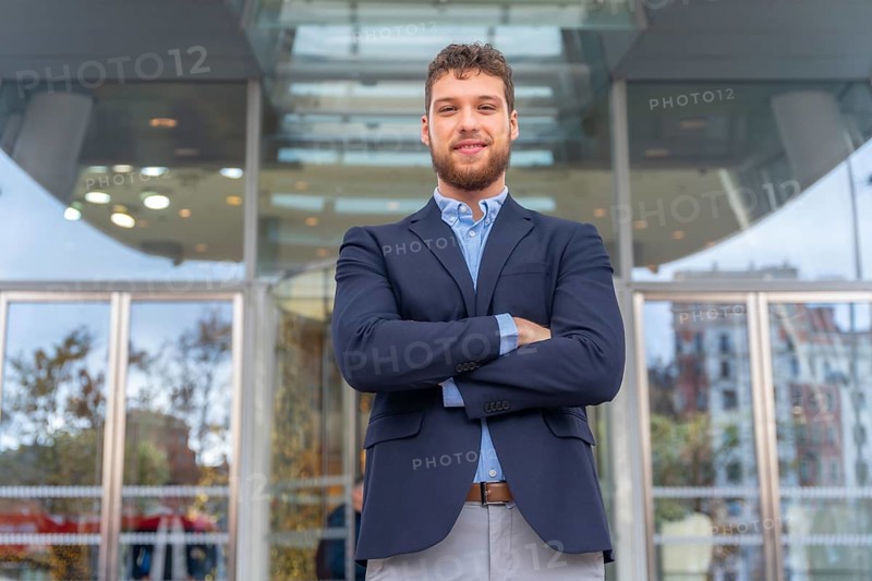 Portrait businessman CEO of a company at glass office entrance