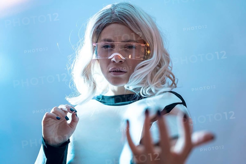 Woman with illuminated futuristic glasses and white hair