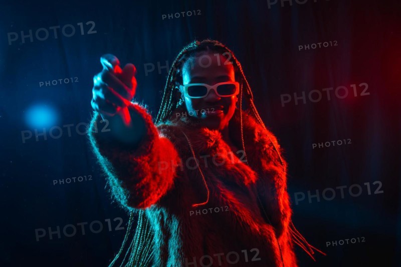 Young african woman with braids with blue and red led lights