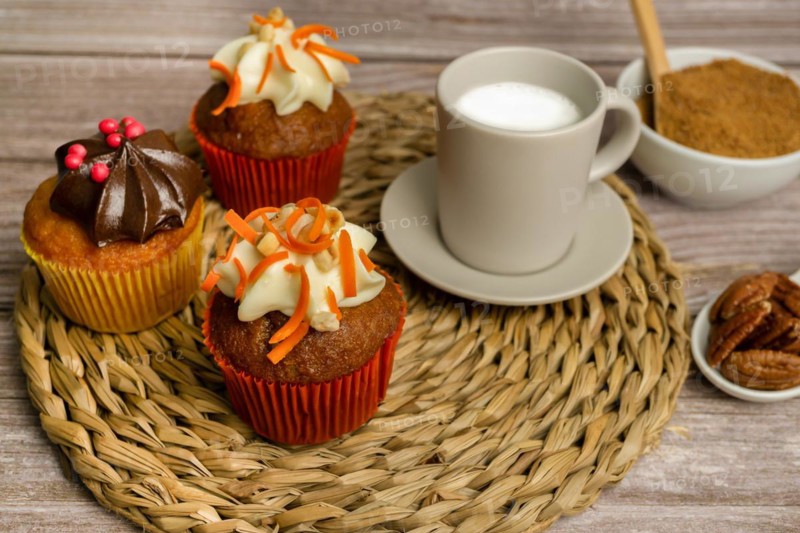 Assortment of chocolate and cream and carrot cupcakes on various backgrounds