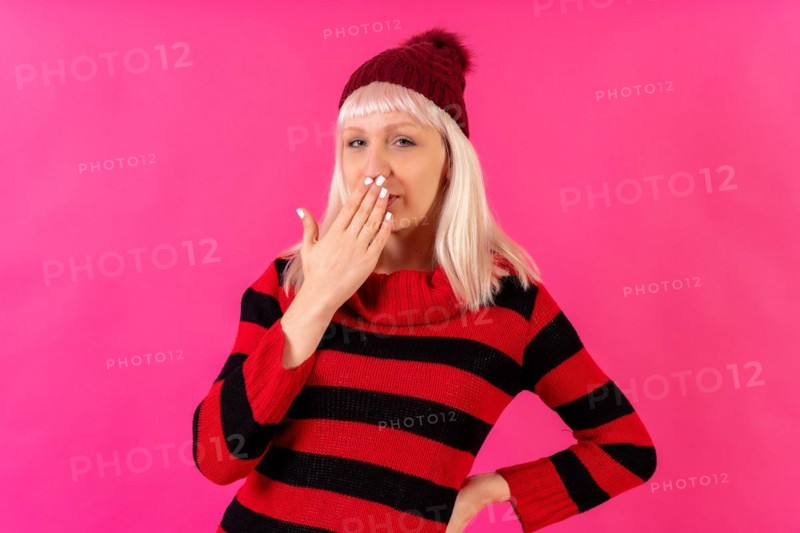 Blonde caucasian girl on pink background studio