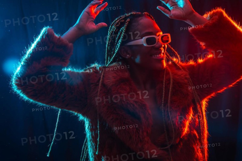 African young woman with braids with blue and red led lights