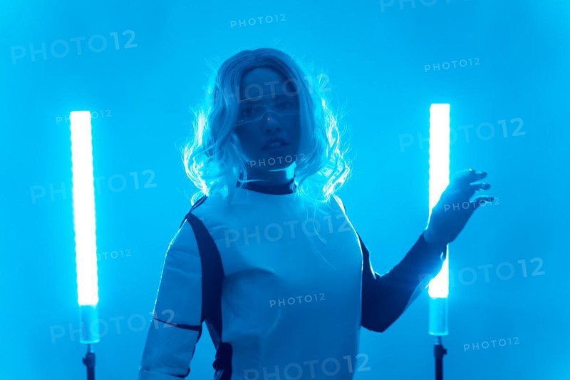 Young woman in futuristic suit and glasses with blue led lights