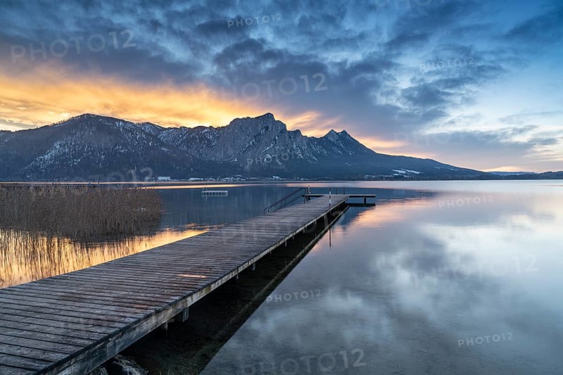 Footbridge with dragon wall at sunset