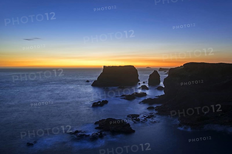 Sea stacks and cliffs at sunset at Eshaness