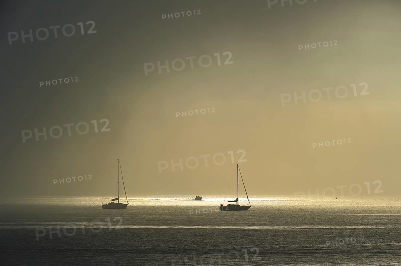 Fog rolling in over sailing boats at sea near the island Ile d'Oleron