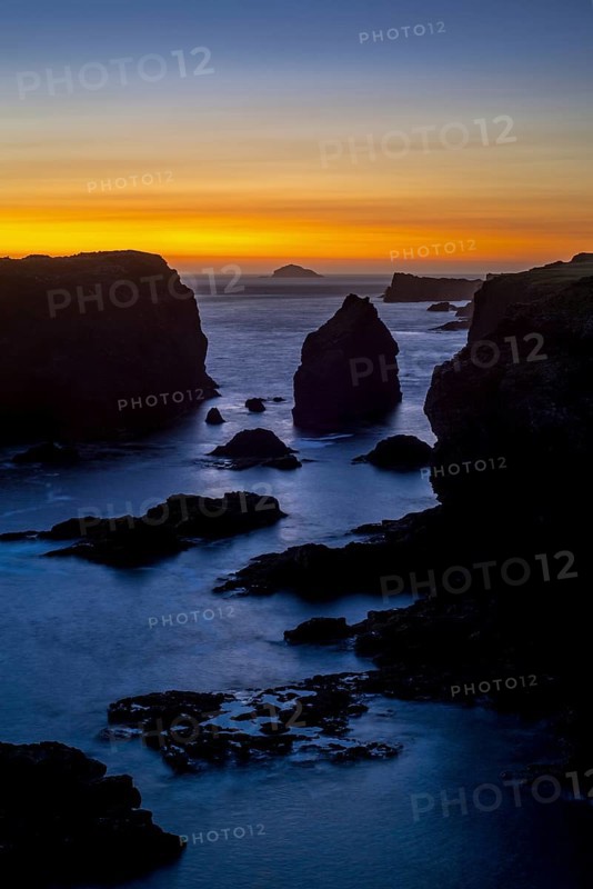 Sea stacks and cliffs at sunset at Eshaness