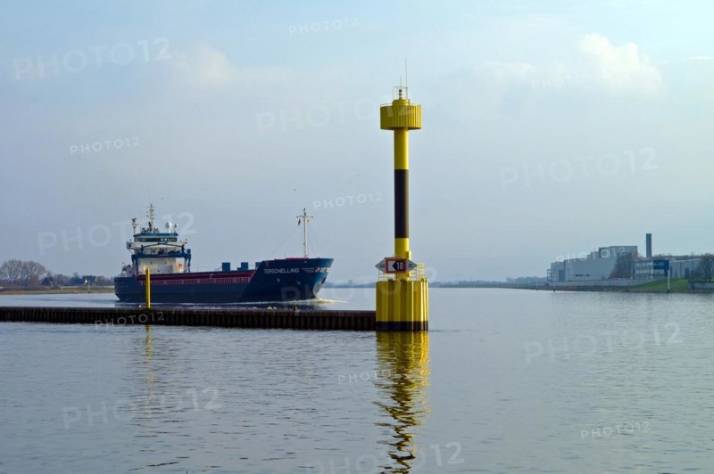 Bremen Vegesack. Cargo ship Terschelling on the Weser. Lighthouse at the mouth of the river Lesu. Germany