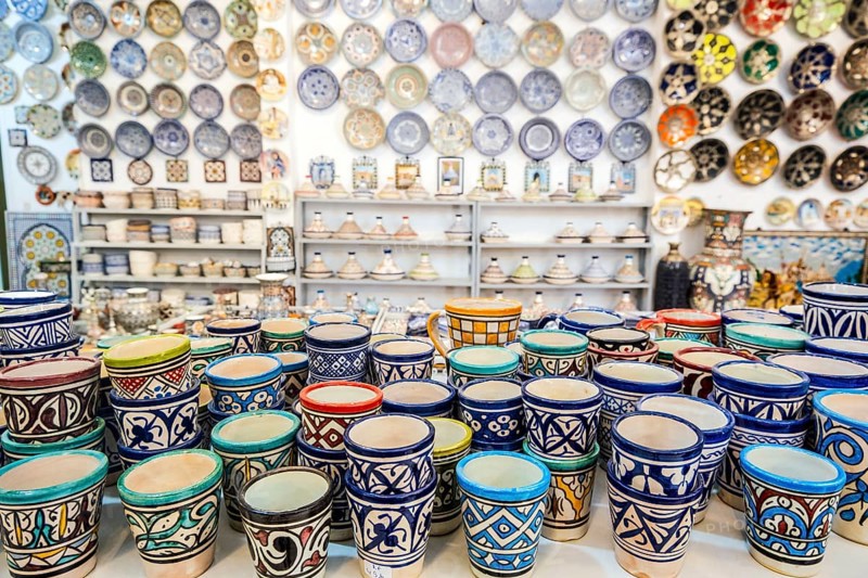 Shelves full of handmade ceramic products in pottery factory in Fez