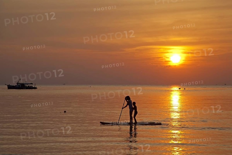 Mother and child standup paddleboarding