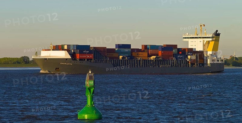 Container ship on the Elbe near Luehe in the evening light
