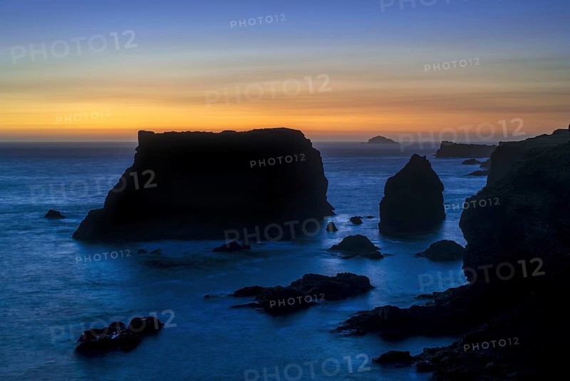 Sea stacks and cliffs at sunset at Eshaness