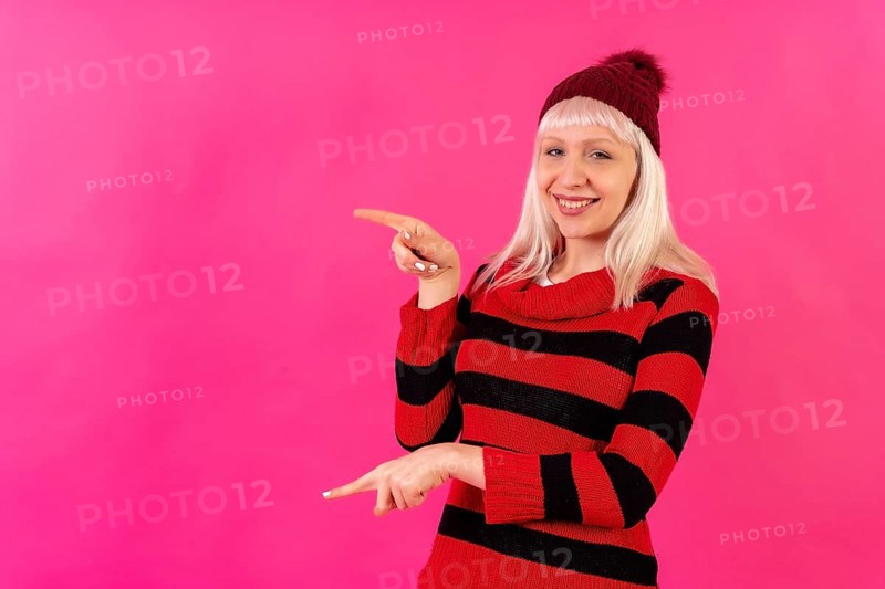 Blonde caucasian girl on pink background studio
