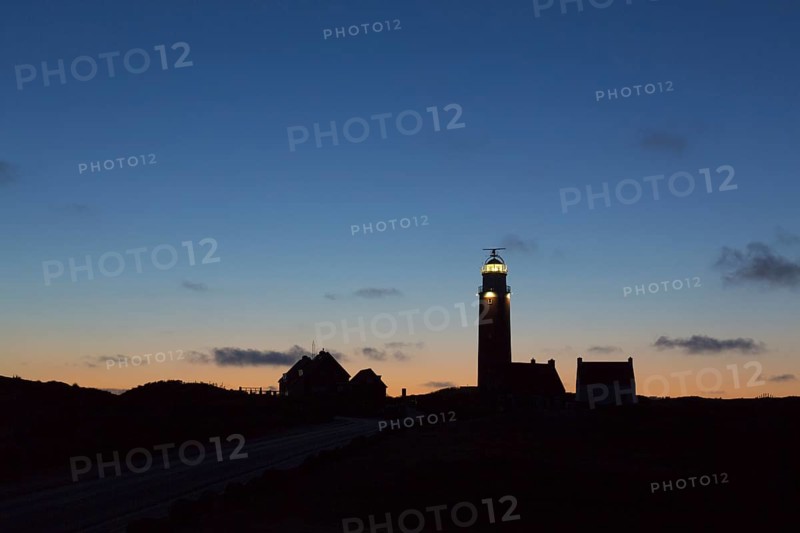 Eierland Lighthouse in the dunes silhouetted against sunset on the northernmost tip of the Dutch island of Texel