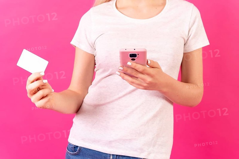 Blonde caucasian girl in pink studio background