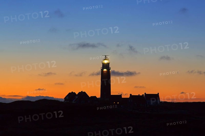 Eierland Lighthouse in the dunes silhouetted against sunset on the northernmost tip of the Dutch island of Texel