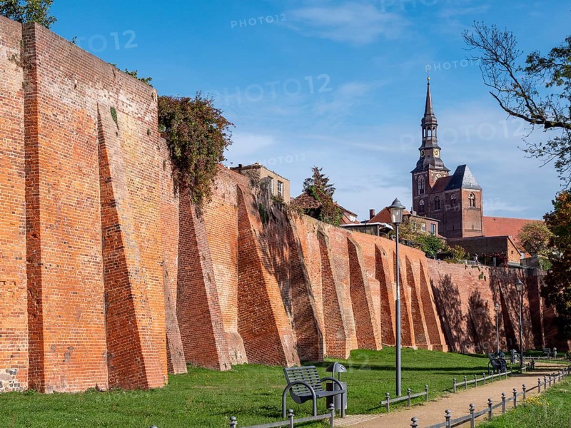 Brick city wall and in the background the Protestant Church of St. Stephan