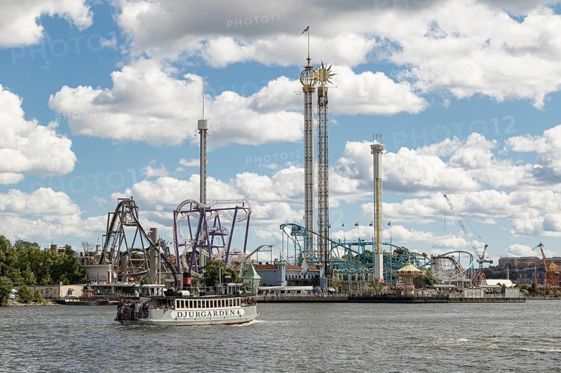 Ferry in the harbour and rides at Tivoli Groena Lund amusement park on the Djurgarden peninsula