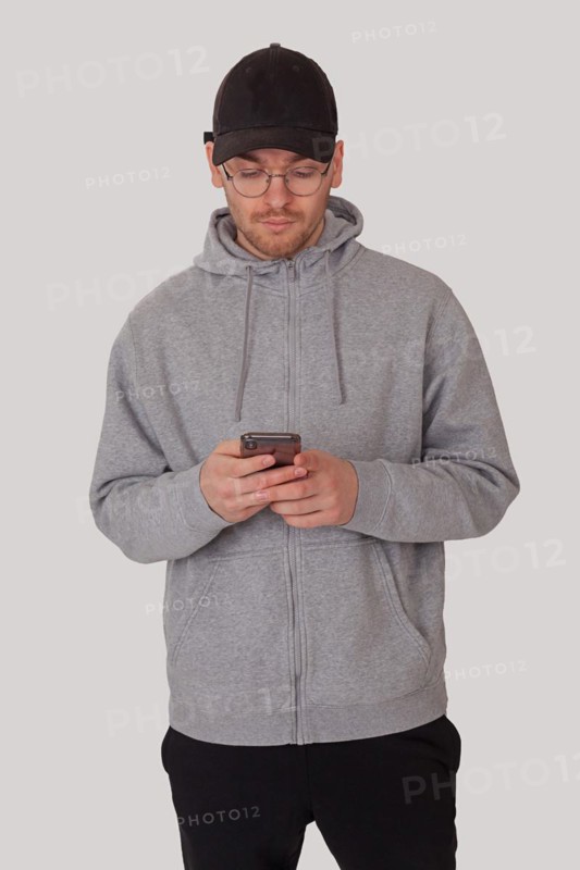 Fashionably sporty man typing on his mobile phone