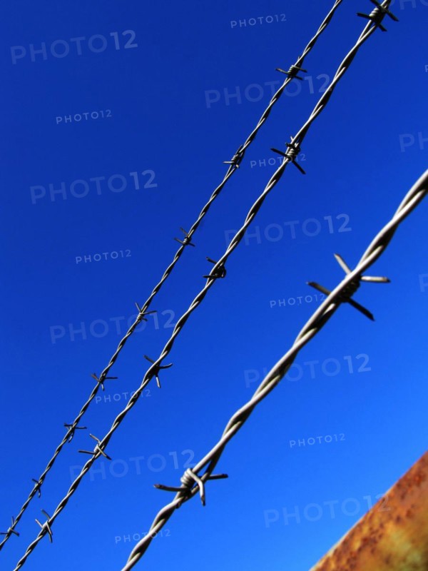 Barbed wire against a blue sky